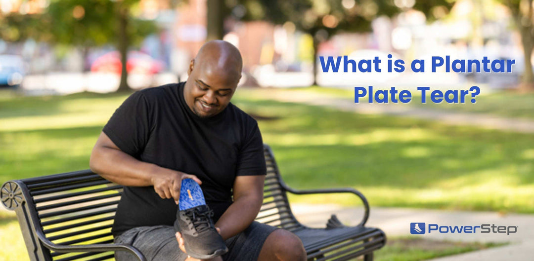 Man sitting on a park bench putting orthotic insoles into his shoes