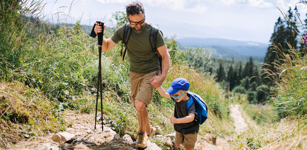 Father and son hiking during the summertime, pain free from the arch support of PowerStep shoe inserts