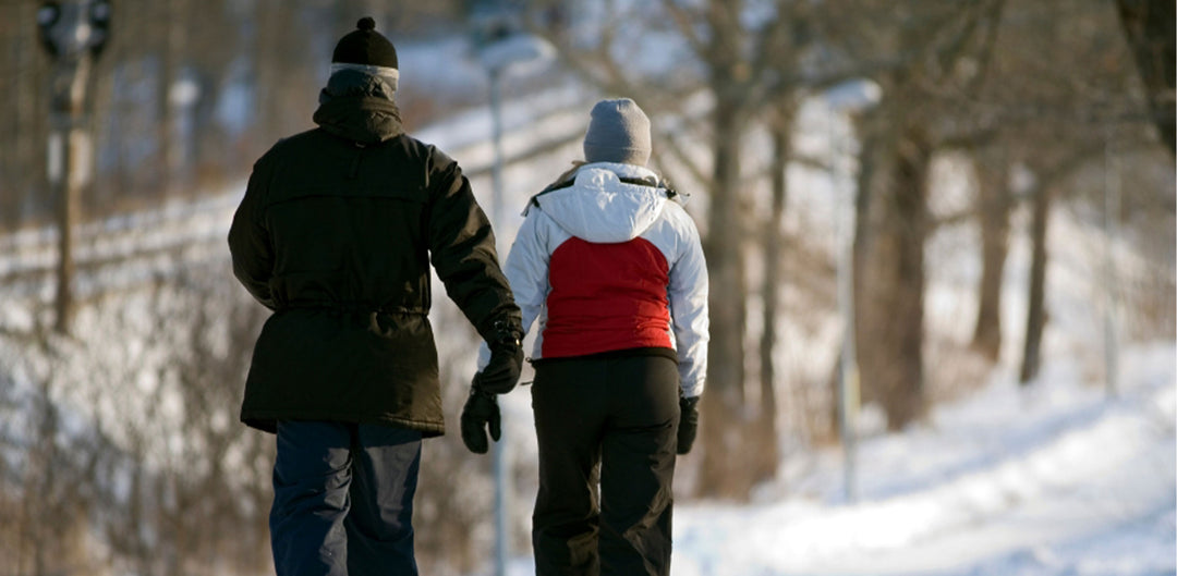 Couple walking on a trail in the snow