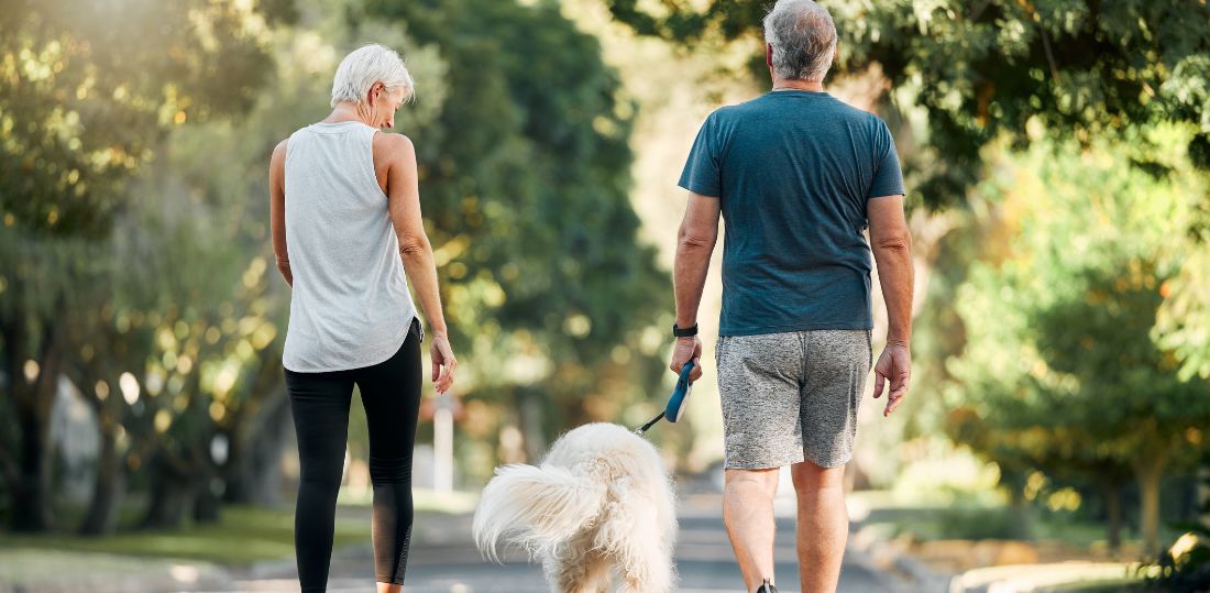 Couple walking with their dog
