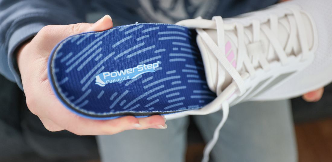 PowerStep Pinnacle going into a white tennis shoe