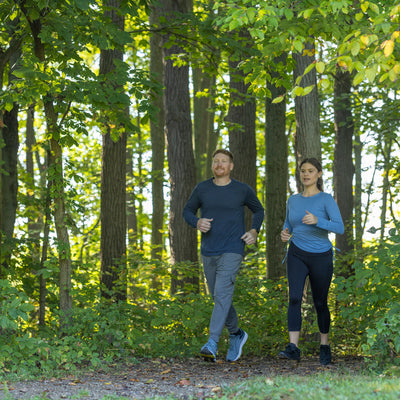 Man and woman jogging at the park while wearing PowerStep PULSE insoles